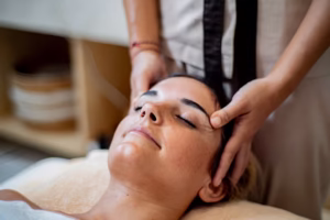 Woman receiving massage ubud bali spa treatment in open tropical pavilion
